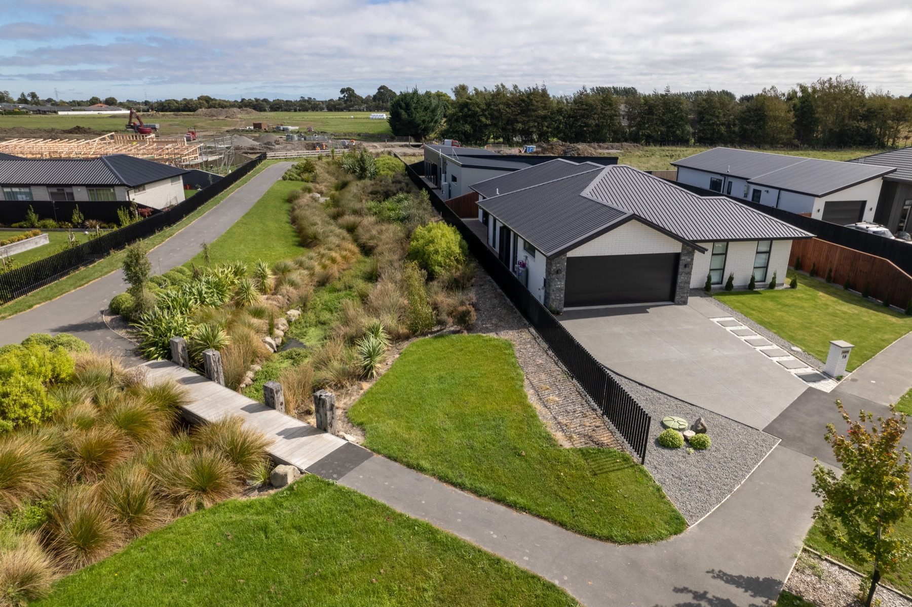 Aerial view over the Milns Park home and its rear lawn.