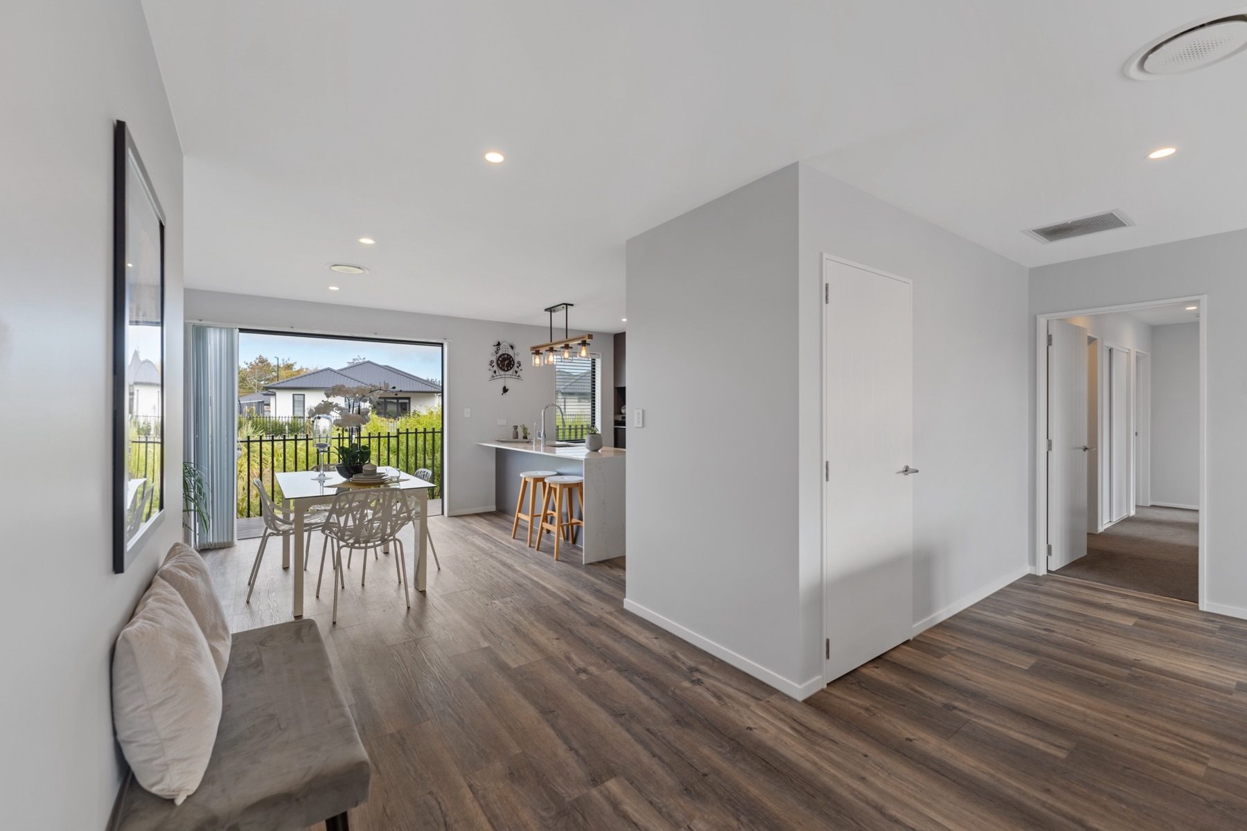 The centre of the plan at Milns Park: dining and kitchen to the left, a central storage core, and the bedroom hallway to the right.