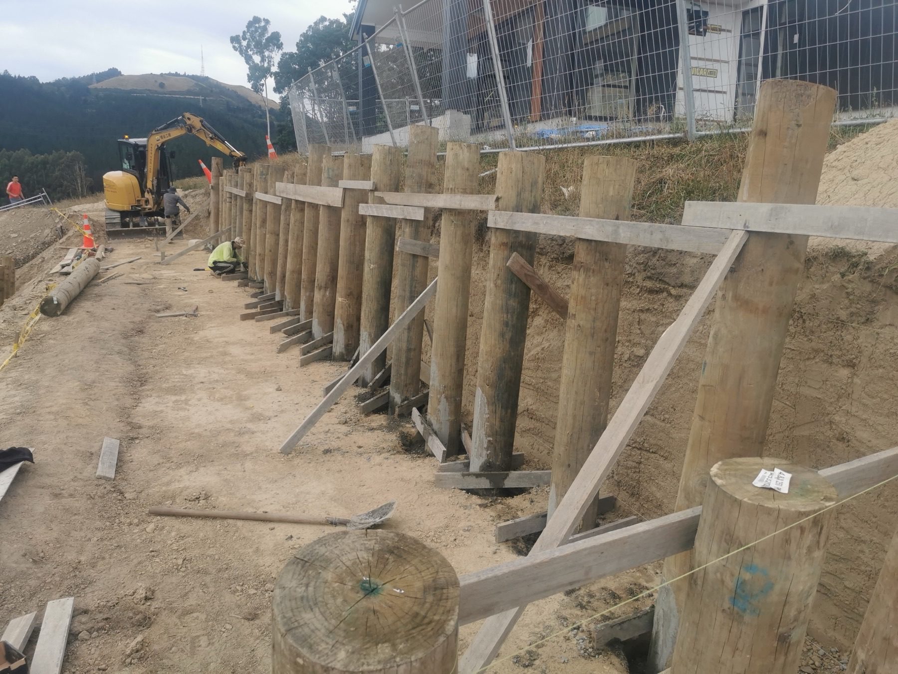 The excavated hillside platform at Round Hill Rise, cut face benched and ready for foundations.